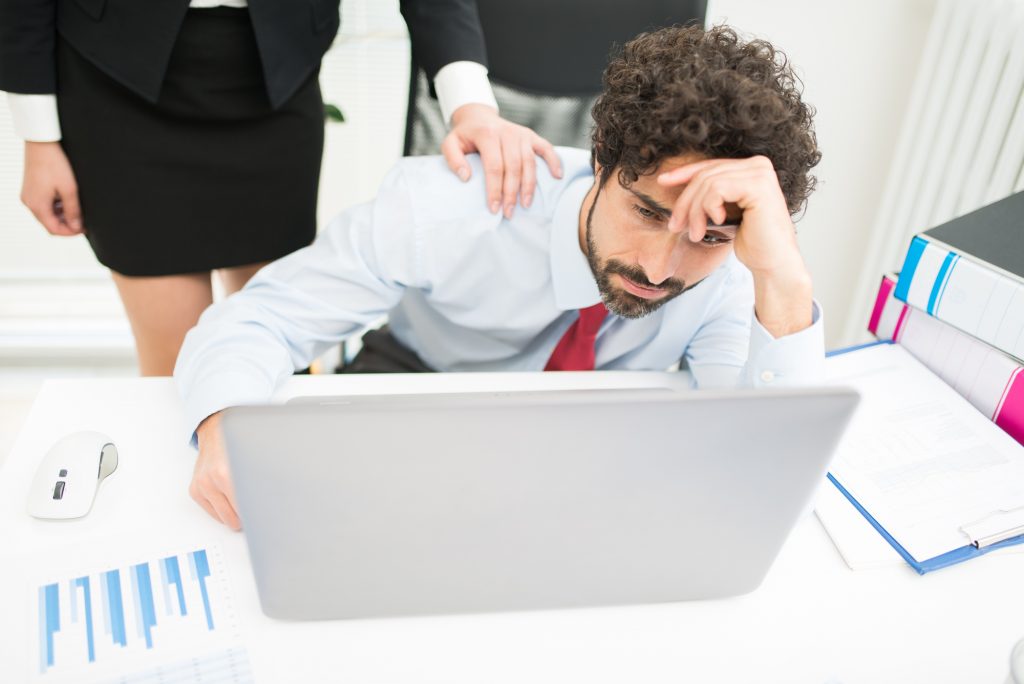 Depressed businessman looking at his computer